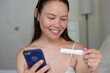 A hopeful woman taking a pregnancy test, trying to have a baby.