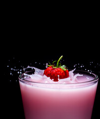 Wall Mural - Bright red strawberries fall into a bright pink glass. cause water distribution on a black background