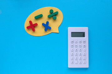 Wall Mural - Colorful mathematical shape (Plus, minus, multiply, divide) and calculator on a blue background.