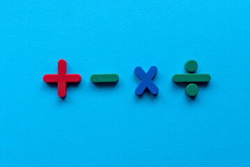 Wall Mural - Colorful mathematical shape (Plus, minus, multiply, divide) on blue background.