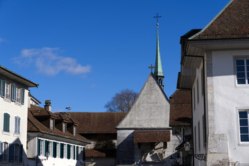 Wall Mural - Historic houses with St. Peter Chapel at the old town of Solothurn on a sunny winter day. Photo taken February 7th, 2022, Solothurn, Switzerland.