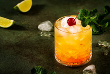 Mai Tai Trendy Alcoholic Cocktail With Rum, Liqueur, Syrup, Lime Juice, Mint And Crushed Ice. Dark Background, Copy Space