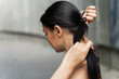 Young woman fastening her ponytail with elastic