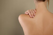 © New Africa - Back view of woman with perfect smooth skin on beige background, closeup. Beauty and body care