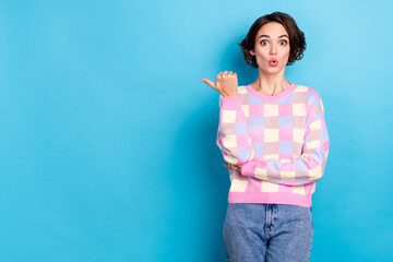 Poster - Photo of young woman impressed indicate finger empty space advert proposition decision isolated over blue color background