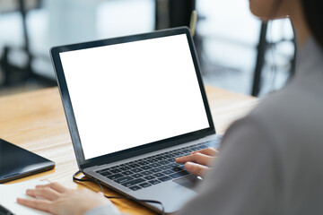 Close up image of a female assistant working on laptop computer at her workspace. laptop blank screen mockup.