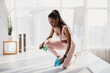 © Prostock-studio - Millennial African American woman in sportswear wiping yoga mat after training at home gym, empty space
