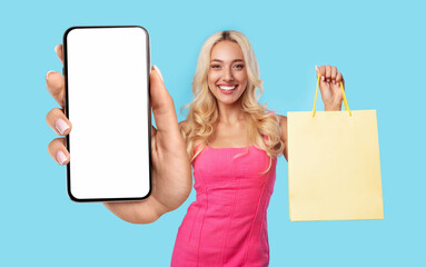 Canvas Print - Blonde woman holding shopping bag and showing empty smartphone screen