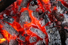 Close up of hot coals burning in a fire.