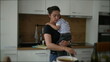 © Marco - Mother cooking while holding baby toddler child