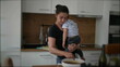 © Marco - Mother cooking while holding baby toddler child