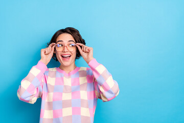 Poster - Photo of young curious lovely woman eyewear look empty space dreamy isolated over blue color background