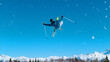 © helivideo - Active young male tourist on a skiing trip does breathtaking high-flying tricks.