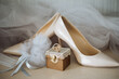 © ADDICTIVE STOCK - Bridal veil against wedding rings on box and shoes