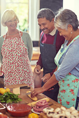 Poster - nothing better than food, fun and friends. shot of a group of mature friends cooking at home.