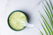 © IKvyatkovskaya - cosmetic hydrogel patches for moisturizing and nourishing the skin around the eyes. Tropical leaf on background. caring for the face, flatlay.