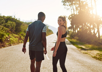Poster - My guy makes the best workout buddy. Shot of a fit young couple slowing down for a walk during their run outdoors.