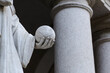 detail of a marble sculpture with a hand holding a world-sphere. Monument in a public place with sculpture to geometry, in memory of  astronomer mathematician bonaventura cavalieri, created in 1844.