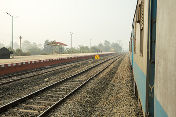 Poster - A Indian Railway line near a small station.