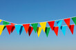 Buntings with colorful triangular flags against blue sky
