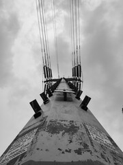 Low angle or frog level view of the tall power line pole