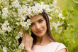 © millaf (Nemchinova) - Fashionable woman with flowers around the head. Happy beautiful young model in spring blossom park.