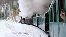 View Of The Moving Steam Train Mocanita From Inside It, Bare Forest In Winter, Snow, Filming Passengers, Romania
