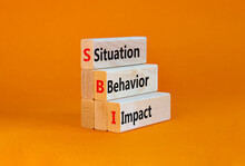 SBI Situation Behavior Impact Symbol. Concept Words SBI Situation Behavior Impact On Blocks On A Orange Table, Orange Background. Psychological SBI Situation Behavior Impact Concept. Copy Space.