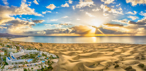 landscape with maspalomas town and golden sand dunes at sunrise, gran canaria, canary islands, spain