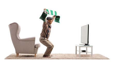 Poster - Full length profile shot of an elderly man with a football scarf cheering in front of tv