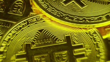 Wall Mural - Golden coins spin and shine. Bitcoin BTC virtual money produced by blockchain technology