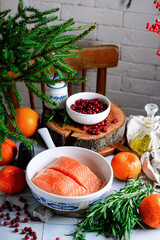 Wall Mural - Baked salmon with tangerines in cranberry sauce in a white pan.style vintage