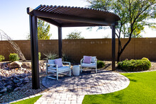 Small Back Yard Pergola With Two Sitting Chairs On Round Pavers Patio