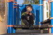 child playing fun in the park and playing with the mobile phone