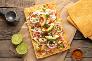 Wall Mural - Snack made with wheat flour called chicharron preparado with sauce and vegetables. Mexican food