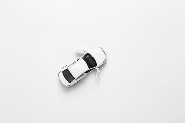 White toy car model against white background. Top view