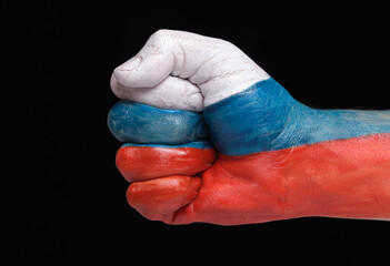 Fist hand is painted in colors flag Russian Federation, on a black background of isolate.