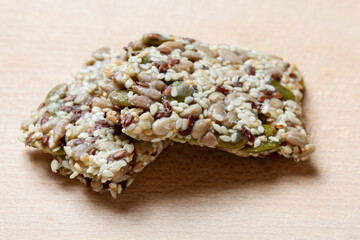 Poster - A muesli bar with seeds on a wooden table.