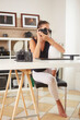 © Stocked House Studio - Portrait of beautiful caucasian photographer woman working home office holding camera with desktop. Business people employee freelance online marketing.