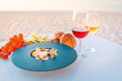 Sunset appetizer with wines and fresh vegetables on beach dinner table. Luxury food background, destination dining closeup. 