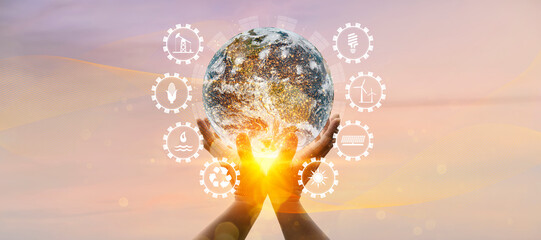 Wall Mural - earth at night was holding in human hands with energy resources icon.