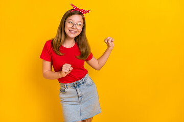 Poster - Photo of adorable sweet positive teen female look empty space dancing freedom isolated on yellow color background