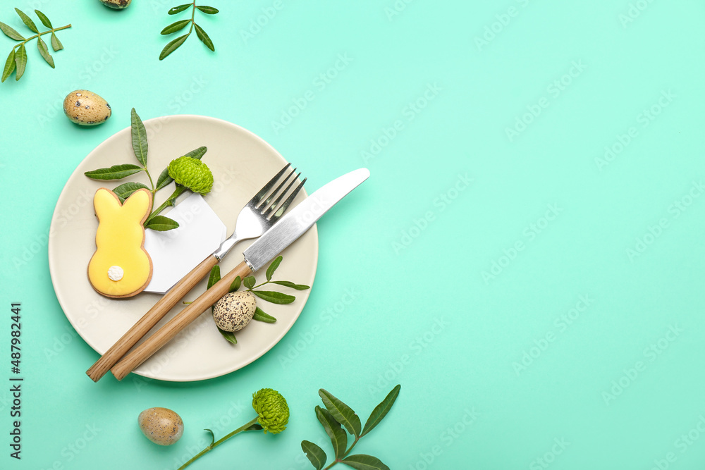 Stylish table setting with Easter cookie on turquoise background