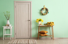 Interior Of Room With Beautiful Easter Decor And Wooden Door Near Color Wall