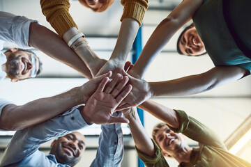 Aufkleber - The supportive team is a strong team. Low angle shot of a group of colleagues joining their hands in solidarity at work.