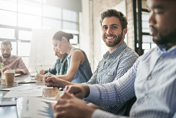 If youre waiting for a sign, this is it. Portrait of a businessman sitting sitting in a meeting.