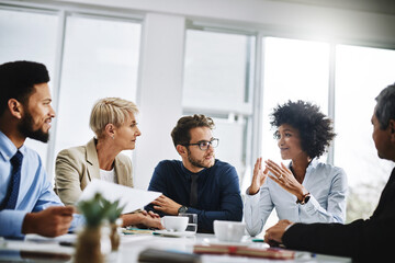 Aufkleber - We will only win by working together. Shot of a group of businesspeople sitting together in a meeting.