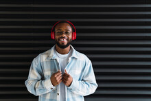 Smiling Black Man In Headphones And Jacket