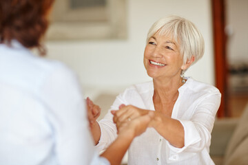 Wall Mural - Enjoying a mother and daughter get-together. Shot of a senior woman holding her daughters hands.