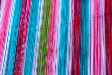 Canvas Print - A closeup image of colorful strands of traditional weaving by the Karen people of Myanmar